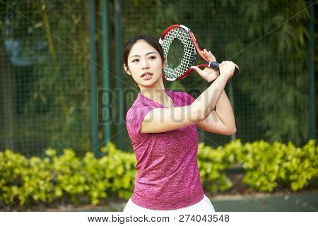 Young Asian Woman Female Tennis Player Hitting Ball With Forehand