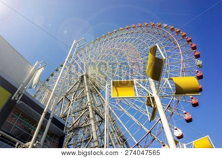 Osaka, Japan, February 21, 2018 : Lookup View Tempozan Giant Ferris Wheel On Bright Blue Sky With Su