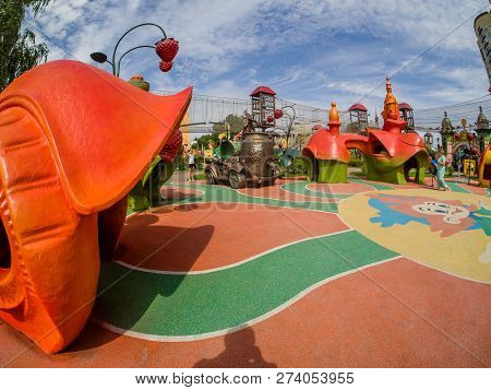 Moscow, Russia - July 26, 2018: Unidentified People Look At  Playground Equipment In Children Amusem
