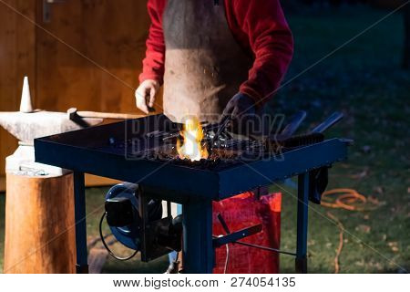 A Craftsman Working With Fire And A Hammer On A Glowing Iron. Middle Age, Flame, Metal, Handmade;