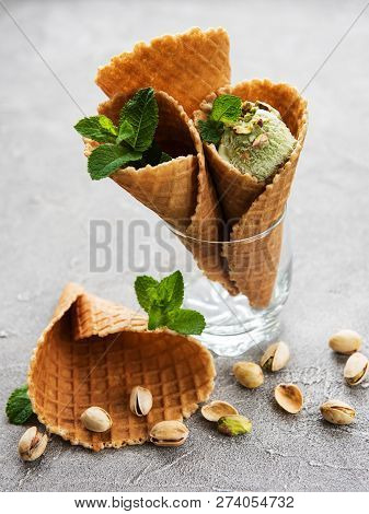Pistachio Ice Cream And Mint With Pistachio Nuts On A Stonebackground