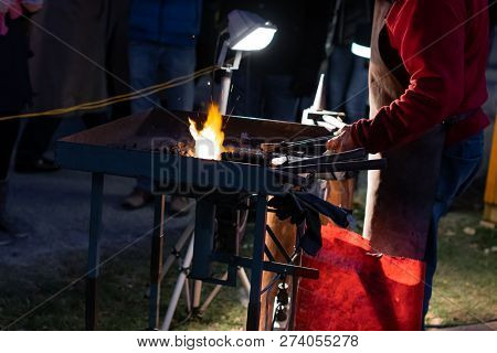 A Craftsman Working With Fire And A Hammer On A Glowing Iron. Middle Age, Flame, Metal, Handmade;
