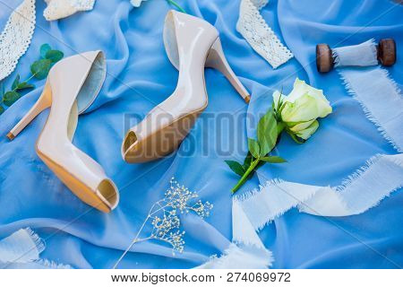 Wedding Shoes. Footwear. Wedding Accessories Of The Bride. Photo Of A Bride Shoes On A Blue Backgrou