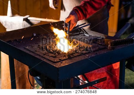 A Craftsman Working With Fire And A Hammer On A Glowing Iron. Middle Age, Flame, Metal, Handmade;