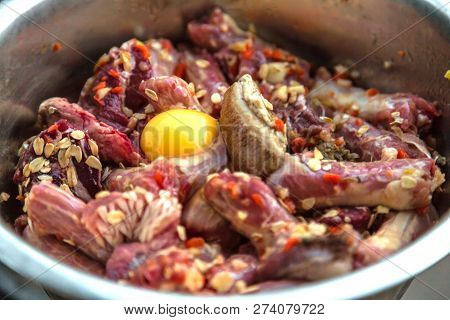 Natural, Organic, Healthy Dog Food (row Meat, Eggs And Chiken Bones) In Metal Bowl. Close Up.