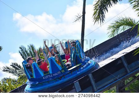 Orlando, Florida. October 19, 2018. Family On Board Raft Boat Enjoying Infinity Falls Over Cloudy Li