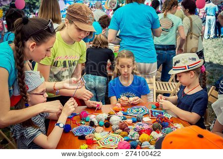 Zaporozhia/ukraine- June 2, 2018: Charity Family Festival-young Woman - Volunteer Explaining To Girl