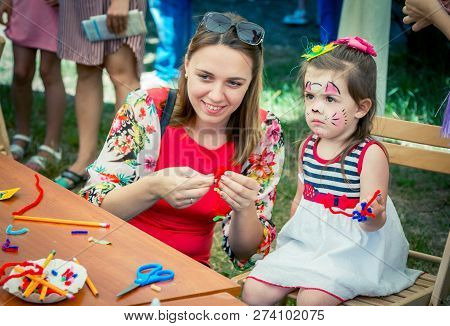 Zaporozhia/ukraine- June 2, 2018: Charity Family Festival -  Mother And Daughter - Small Girl With F
