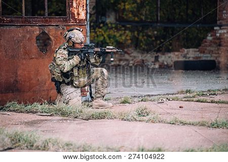 Kyiv, Ukraine - October 14, 2017: Soldier Aims With Rifle On His Knee During Airsoft Military Simula