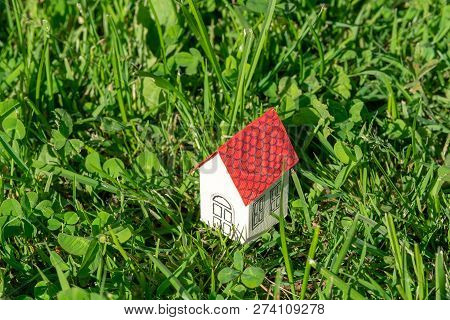 A Small Cardboard House In Strava On The Field