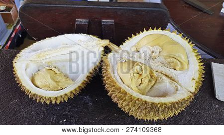 Just Opening Fruit Durian. Bright Yellow Tropical Fruit. Durian Is Covered Around With Thorns.