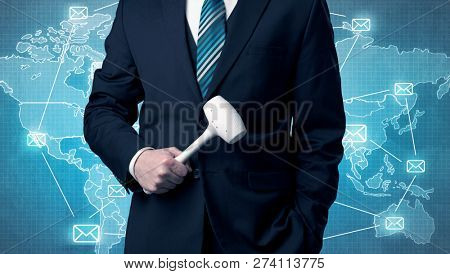 Businessman holding tool with global map graphic on the background