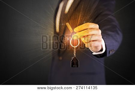 Formal man hand over shiny keys with dark background