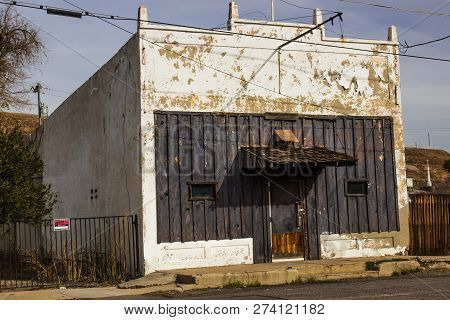 Abandoned Commercial Building With Peeling Paint In Depressed Area