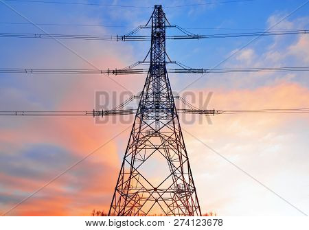 A Transmission Tower Or Electricity Pylon With Blue Sky. It Is A Tall Structure, Usually A Steel Lat
