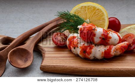 Surimi With Lemon, Tomato And Dill On A Wooden Board Close-up.
