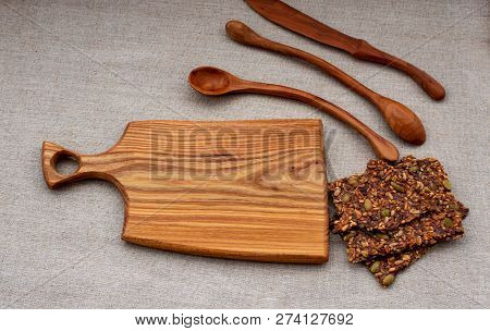 Toasts Of Grain And Seeds On A Wooden Board With Wooden Spoons.