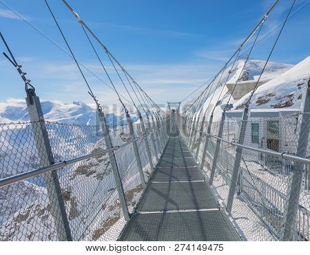 Suspension Bridge Along The Cliff Of Mt. Titlis In Switzerland In Winter.