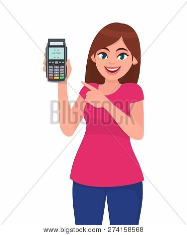 Young Woman Showing/holding Pos Payment Terminal Or Credit/debit Cards Swiping Machine And Pointing 