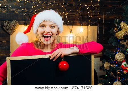 Christmas Woman Holding A Black Desk For Text. Black Board Copy Space. Woman Christmas. New Year Gir