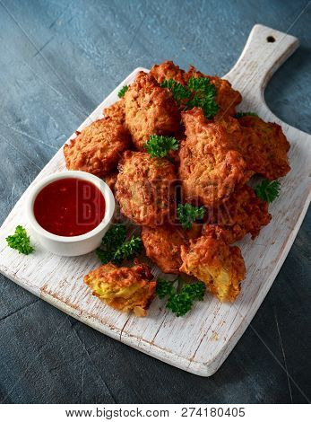 Crispy Onion Bhajis With Sweet Chilli Sauce On White Wooden Board
