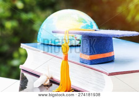 Graduate Or Education Knowledge Learning Study Abroad Concept : Blue Graduation Cap On Textbook With