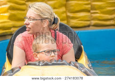 A Caucasian Mother And Her Son Enjoying At Amusment Park