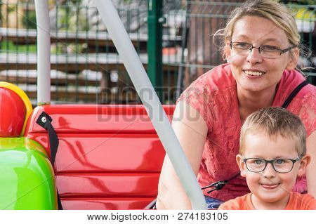 A Caucasian Mother And Her Son Enjoying At Amusment Park