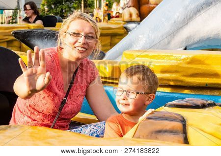 A Caucasian Mother And Her Son Enjoying At Amusment Park