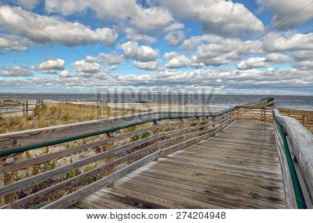A Long Wooden Fishing Pier  In Bayshore Waterfront Park In Monmouth County New Jersey.