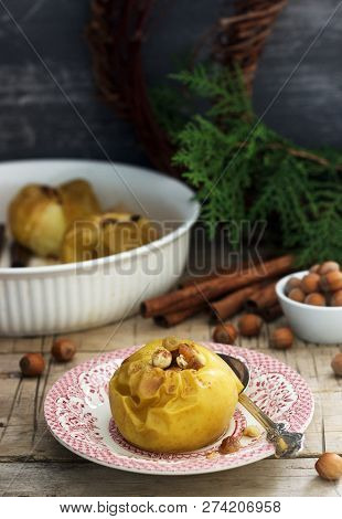 Baked Apples With Raisins, Hazelnuts And Cinnamon On Wooden Background. Rustic Style.