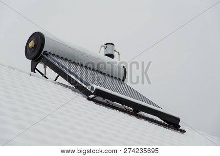 Empty Solar Water Heater Boiler On Residentual House Rooftop At A Cloudy Cold Winter Day.