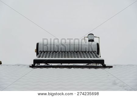 Empty Solar Water Heater Boiler On Residentual House Rooftop At A Cloudy Cold Winter Day.