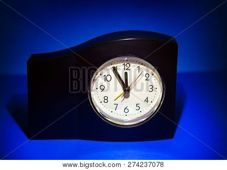 Clock In The Dark Room With Display Almost Midnight