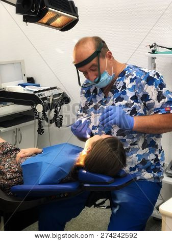 Nikolaev, Ukraine, 09.06.2018. The Orthodontist Preparing The Injection Of Anesthesia For Young Girl