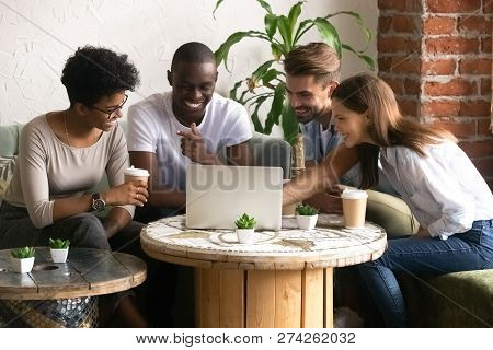 Happy Smiling Diverse Friends Using Laptop Together In Cafe