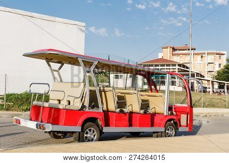Red Open Sightseeing Tourist Minibus Staying Along Sidewalk In Byala, Bulgaria.