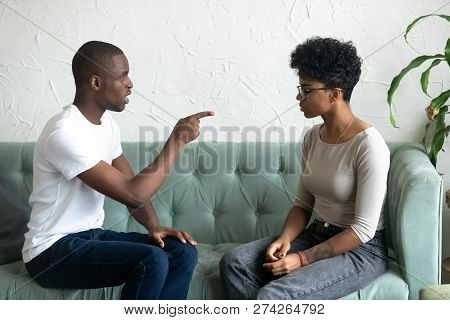 Serious African American Man Blaming Upset Woman, Pointing Finge