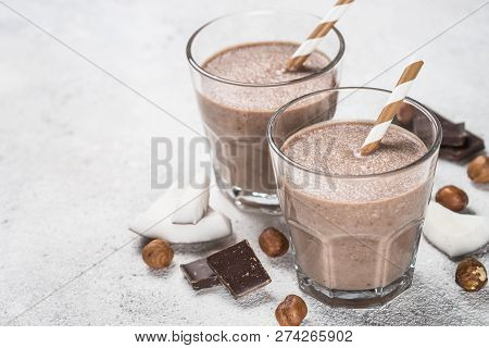 Chocolate Coconut Hazelnut Milkshake Or Smoothie In Two Glasses On White Table.