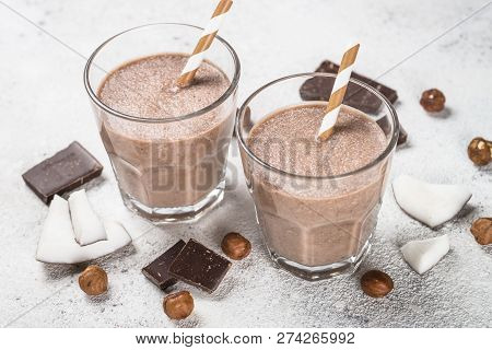 Chocolate Coconut Hazelnut Milkshake Or Smoothie In Two Glasses On White Table.