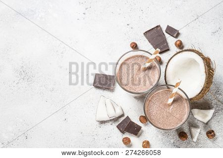 Chocolate Coconut Hazelnut Milkshake Or Smoothie In Two Glasses On White Table. Top View With Copy S