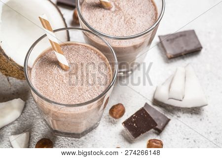 Chocolate Coconut Hazelnut Milkshake Or Smoothie In Two Glasses On White Table. Close Up.
