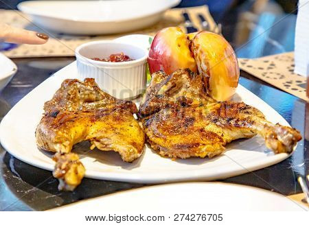 Baked Duck With Apples Lying On A Plate.