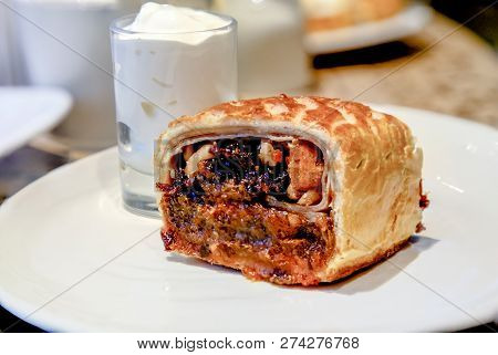 Strudel With Prunes, Dried Apricots And Nuts Lying On A Plate.