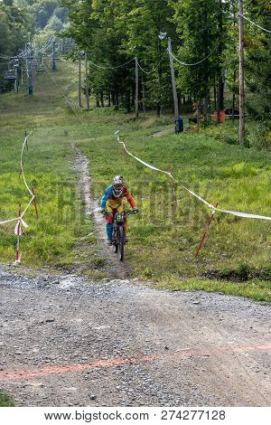 Bromont, Quebec - September 1, 2018 - Vertical Of A Colorful Dirt Bike Racers Competing On A Ski Hil