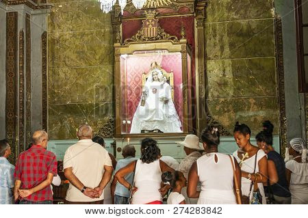 Havana, Cuba - 25 July 2018: People Praying, Lighting Candles And Leaving Flowers To Madonna In A Ha