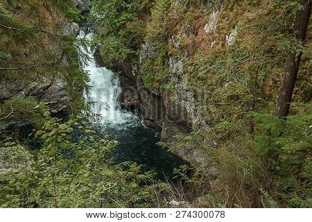Deepblue Pool And Green Forest With Waterfall