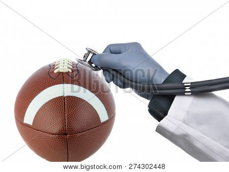 Football Concussion Concept: Closeup of an american football with a doctors hand holding a stethoscope against the ball, isolated on white.