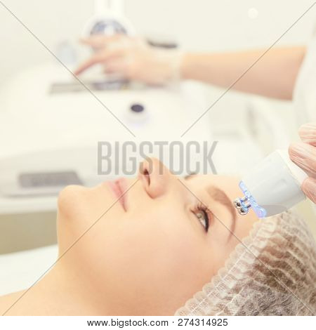 Facial Micro Current Cosmetology Procedure. Beauty Technology Treatment. Woman Face Therapy.