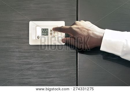 Male Hand Try To Turn On The New Air Condition In Room, In The Hotel Room. African Man Hands On The 